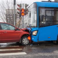 Frontal collision of a car and a bus. Head-on collision between bus and car. Car accident. Traffic accident.
