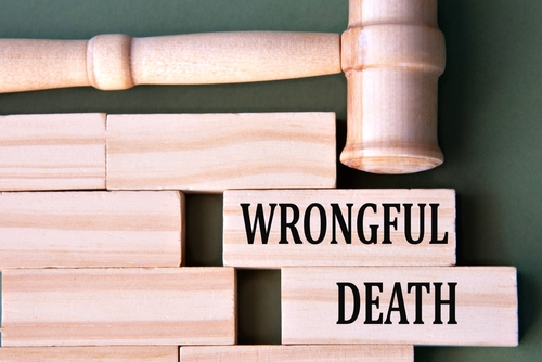 Wooden blocks with the words "Wrongful Death" beside a gavel representing legal action