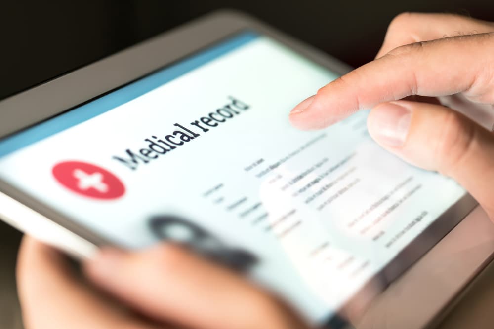 A man is checking Medical Record in tablet
