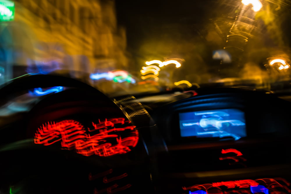 Blurred driver's point of view at night representing impaired driving in Baltimore